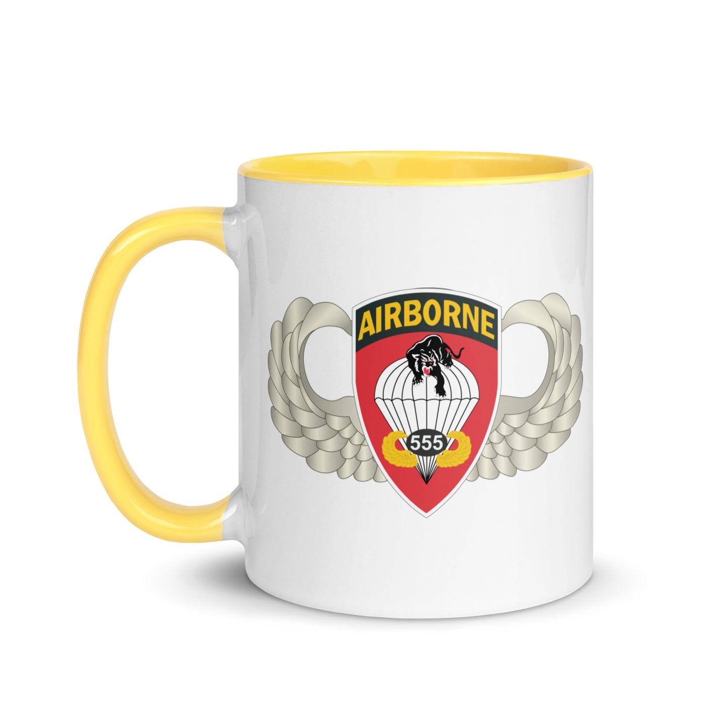 "Ceramic mug with yellow interior featuring 555th Parachute Infantry Battalion SSI, front view"