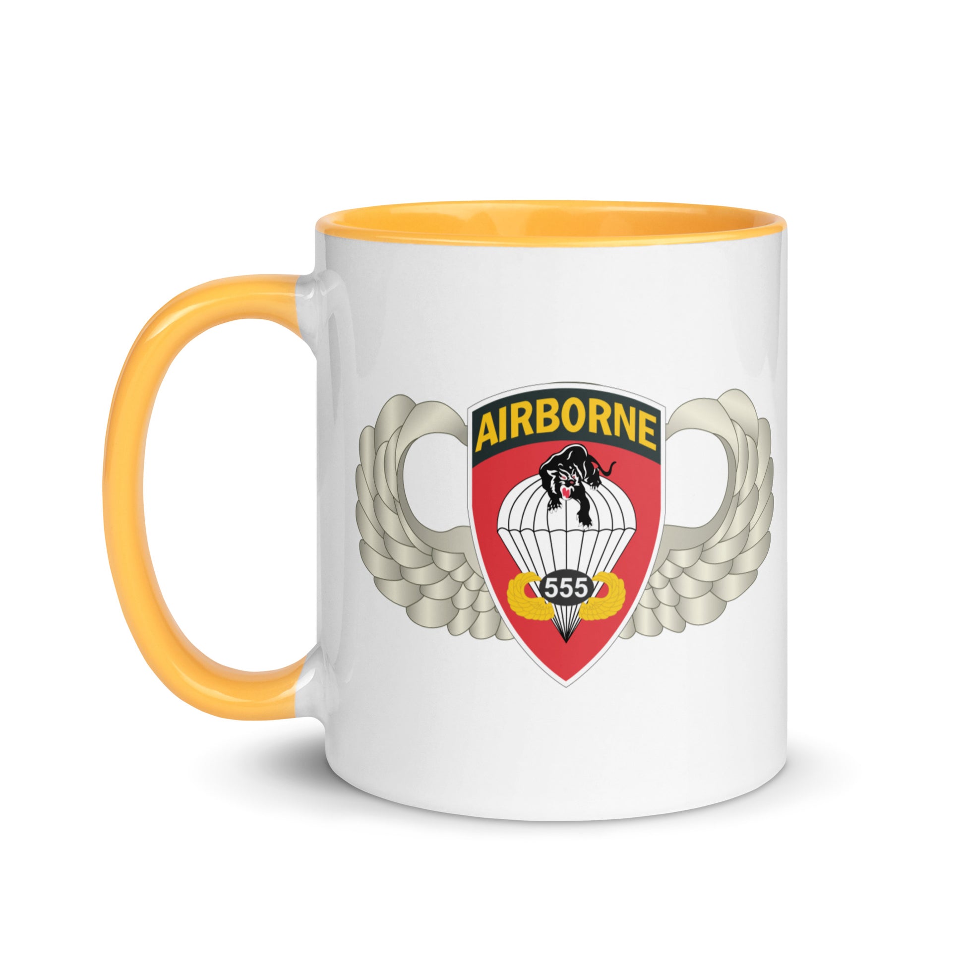  "Ceramic mug with golden yellow interior featuring 555th Parachute Infantry Battalion SSI, front view"